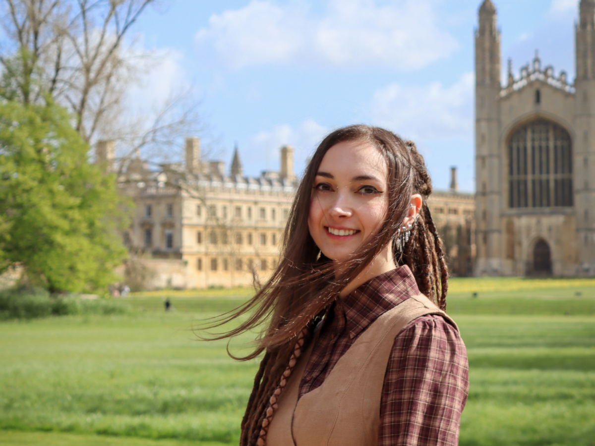 Photograph of Chiara Herzog in front of Kings College Chapel overlooking the Backs