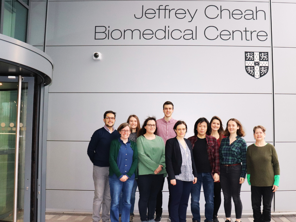 Group photo of the Philpott Group in front of the Jeffrey Cheah Biomedical Centre