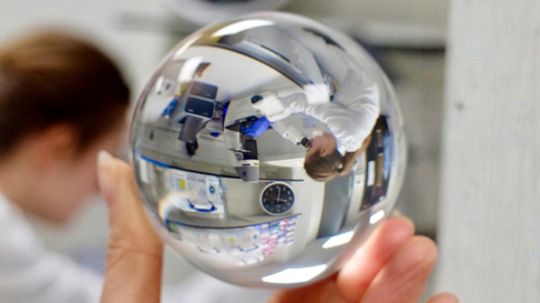 Image of researcher in a lab refracted through a lens